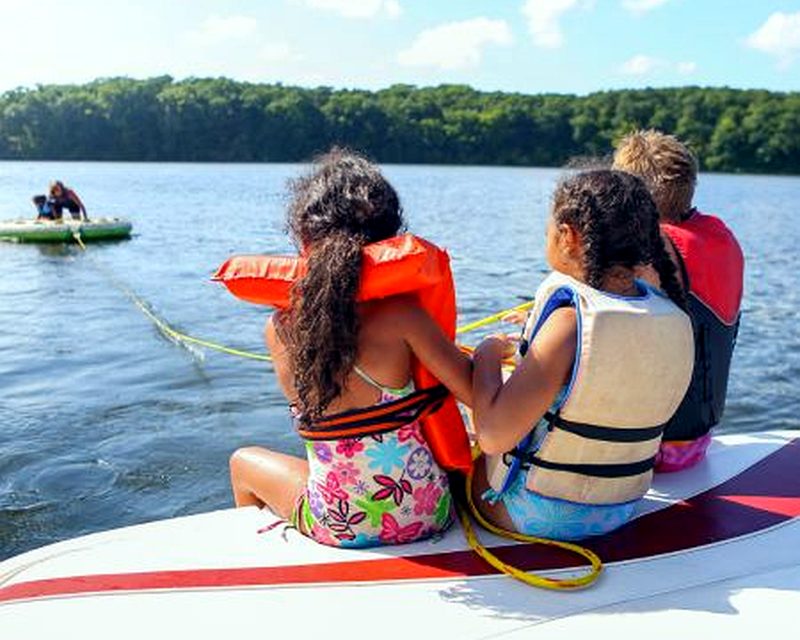 Kids in life jackets on a Minnesota lake
